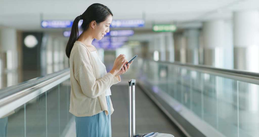 Woman use of smart phone in the airport