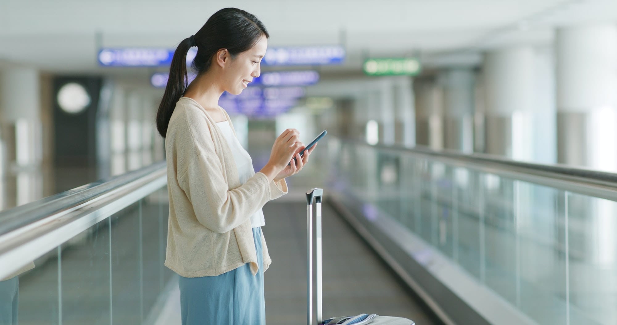Woman use of smart phone in the airport